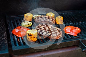 Beef steaks on the grill with flames