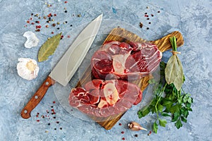 Beef steaks Osso Buco on cutting board.