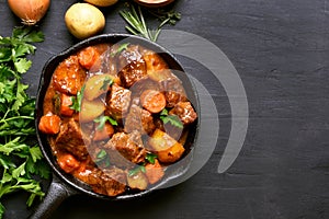 Beef stew with potatoes, carrots and herbs