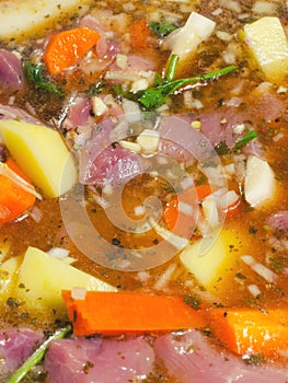 Beef stew in raw state inside pot at start of cooking pot