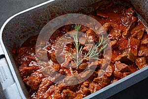 Beef stew with rosemary in a bowl
