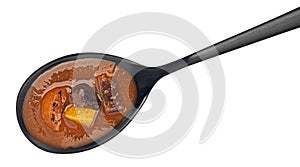 Beef stew in spoon isolated on white background, top view