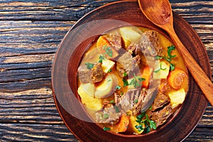 Beef stew in a clay bowl photo