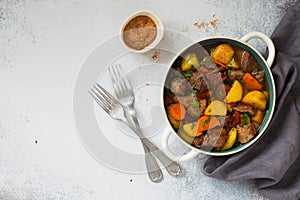 Beef stewed with vegetables on a stone  background