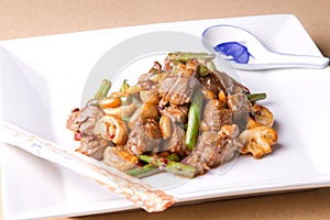Beef stir fry with chopsticks and spoon