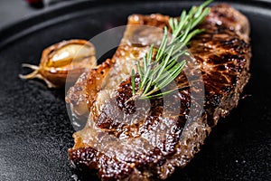 Beef strip loin steak on black background. Space for text. Marble premium beef. Close up