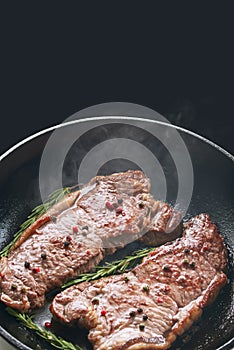 Beef striploin steak in a frying pan