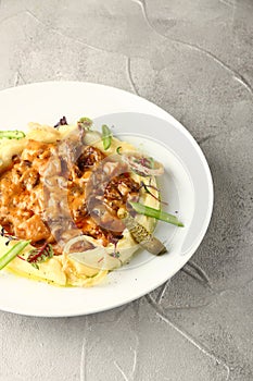 Beef stroganoff closeup with mashed potatoes on light background