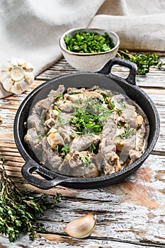 Beef Stroganoff with mushrooms and fresh parsley. White background. Top view