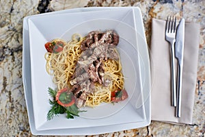 Beef stroganoff with spaghettini in bowl