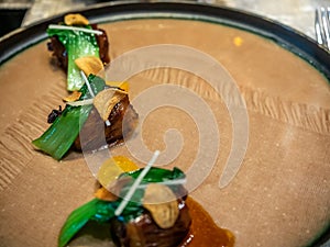 Beef sweet soya sauce decorated on dish in fining cuisine restaurant