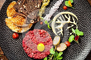 Beef tartare from Black Angus. Onion, quail egg, tomato sauce, mustard mayonnaise. Delicious healthy Italian traditional