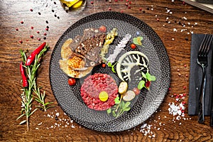 Beef tartare from Black Angus. Onion, quail egg, tomato sauce, mustard mayonnaise. Delicious healthy Italian traditional