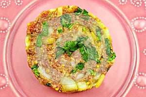 Beef Tartare cold appetizer of raw minced meat with egg yolk, spices, onions, olive oil, lemon juice