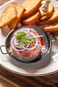 Beef tartare with red onion toast bread and garlic