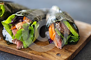 Beef temaki on the wooden board