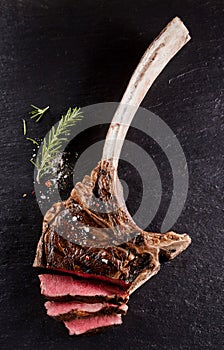 Beef tomahawk rib tip cooked rare and sliced