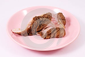 Beef tripe on pink dish