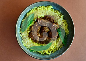 Beef vindaloo with saffron rice on a plate