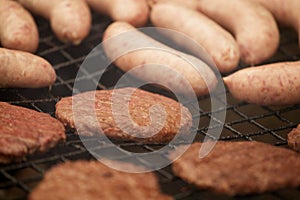 BEEFBURGERS AND SAUSAGES ON BARBECUE