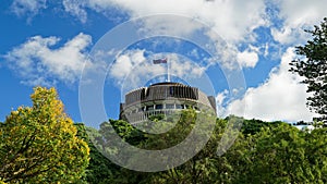 The Beehive above the trees - New Zealand parliament building