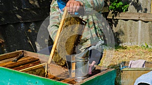 The beekeeper works in the apiary. Beehive and honey production.