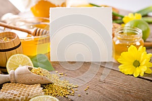 Beekeeping products with lemons on a wooden table