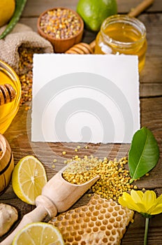 Beekeeping products with lemons on a wooden table