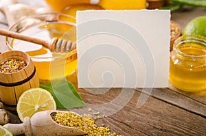 Beekeeping products with lemons on a wooden table