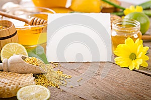 Beekeeping products with lemons on a wooden table