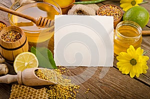 Beekeeping products with lemons on a wooden table