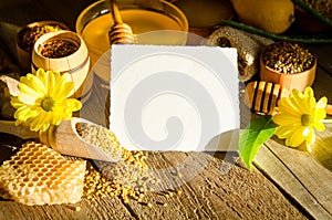 Beekeeping products on a wooden table with empty card for text
