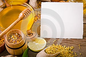 Beekeeping products on a wooden table with empty card for text