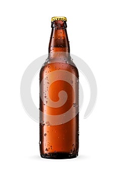 Beer in amber glass bottle with water droplets and ice crystals isolated on white