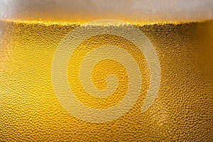 Beer background, with foam drops and sweat, macro close up image