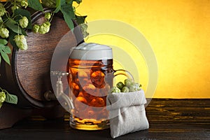 Beer barrel with fresh hop cones and glass of beer