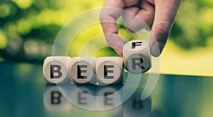 Beer and Beef. Hand turns a cube and changes the word `beef` to `beer`