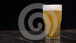 Beer Being Poured into glass, Black Background