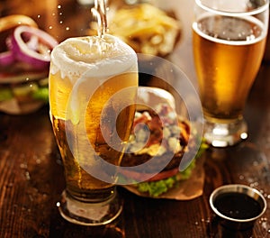 Beer being poured into glass photo