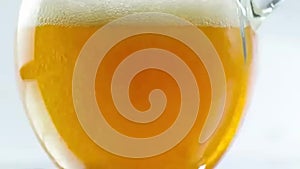 Beer being poured into translucent glass