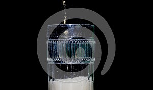 Beer being poured in a water glass