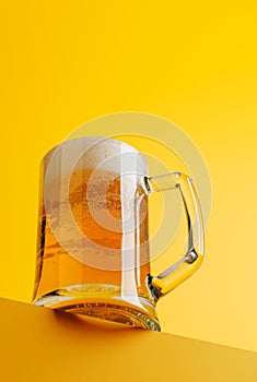 Beer bliss: Refreshing brew against a vibrant yellow backdrop
