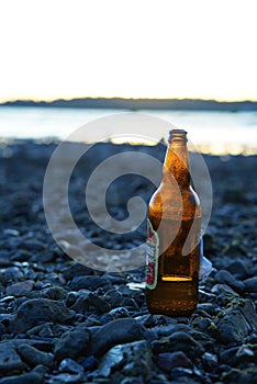 Beer bottle against sunset on beach, Chidiya Tapu, Andaman