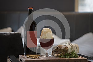Beer bottle, full beer glass on a wooden tray