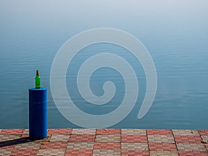 Beer bottle on a mooring bollard