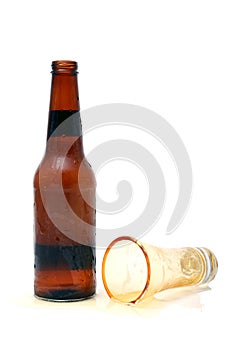 Beer bottle and spilled glass