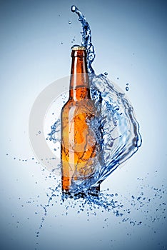 Beer bottle with water splash