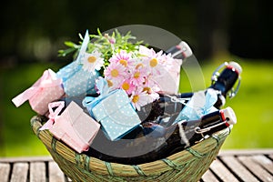 Beer bottles in a basket, with small gifts for Father`s Day