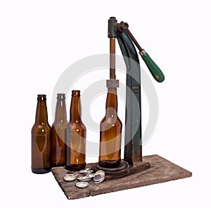 Beer bottles with caps and antique capper