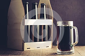 Beer bottles case and mug on a dark background/beer bottles case